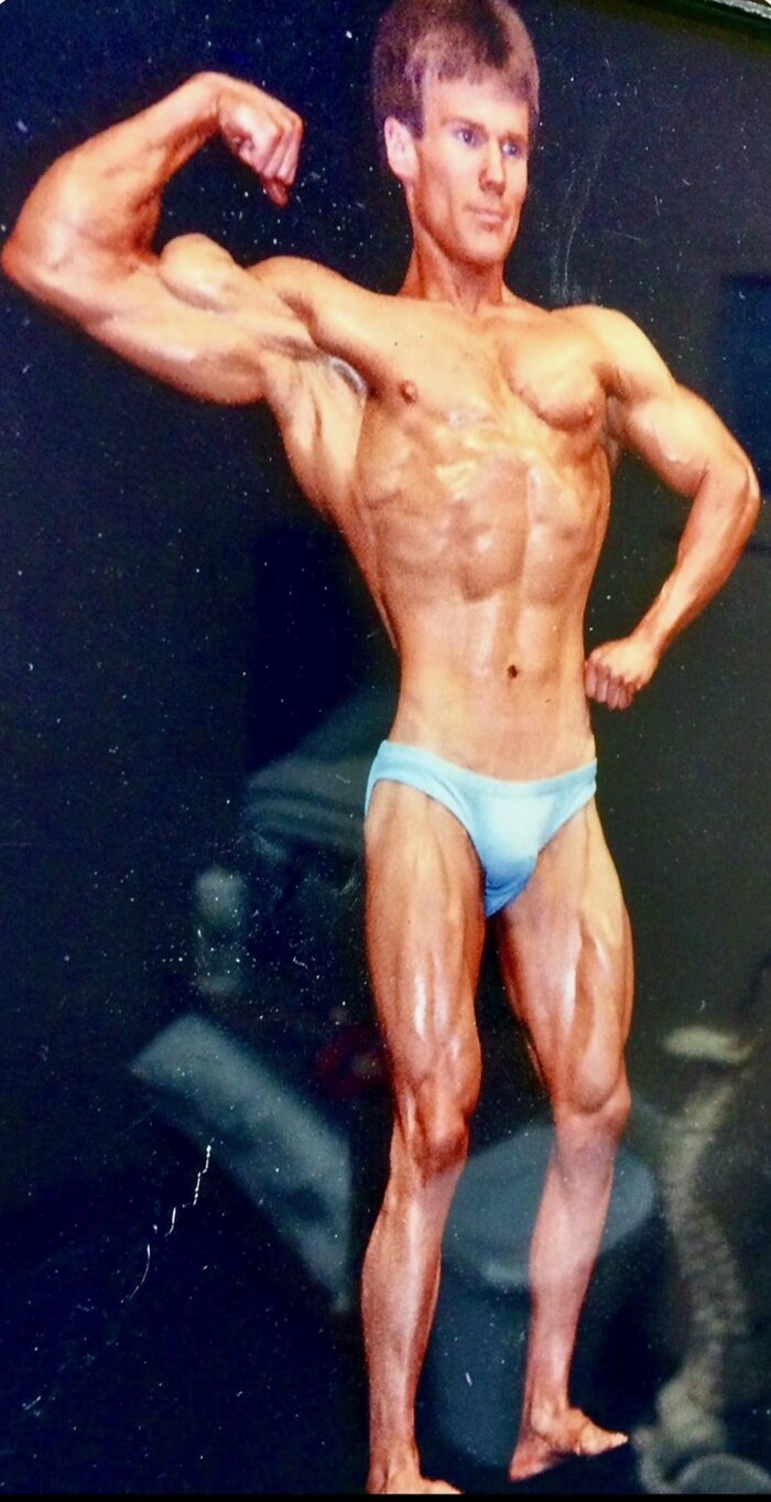 Dr. David Waring holding a competition bodybuilding pose as an NPC Mr. Michigan champion